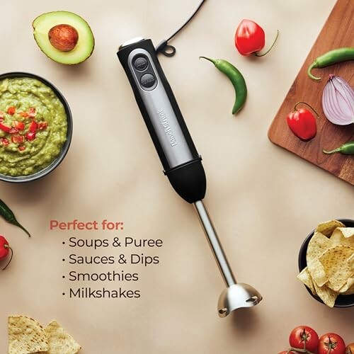 Hand blender surrounded by ingredients for soups and dips.