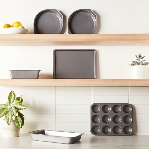 Kitchen shelves with various bakeware items, including pans and a muffin tray.