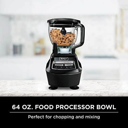 Ninja food processor with cookie dough inside on a kitchen counter