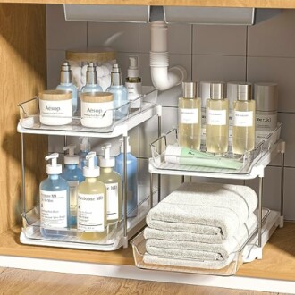 Well-organized bathroom cabinet with toiletries and towels.