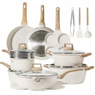 White cookware set with pots, pans, and kitchen utensils.